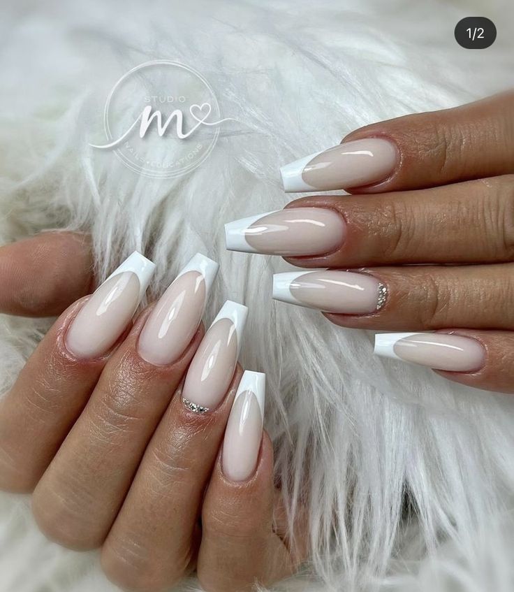 Sophisticated Stiletto and Almond Nail Design: Soft Nude, Crisp White, and Sparkling French Tips.