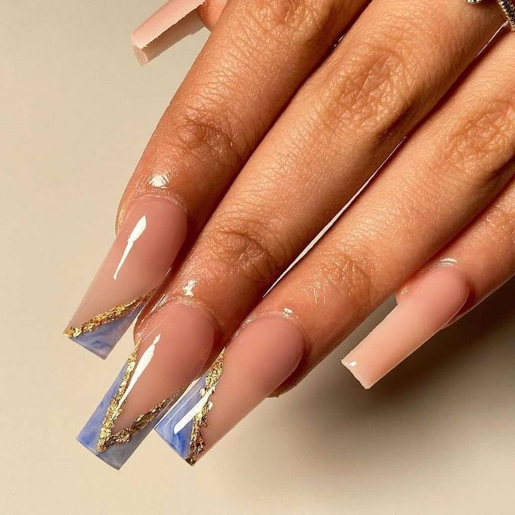 Chic Nail Design: Soft Pink and Striking Blue Tips with Luxurious Gold Foil Accents.