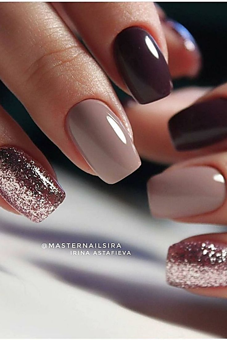 Sophisticated Elegant Nail Design with Deep Colors and Glittery Ombre Accents.