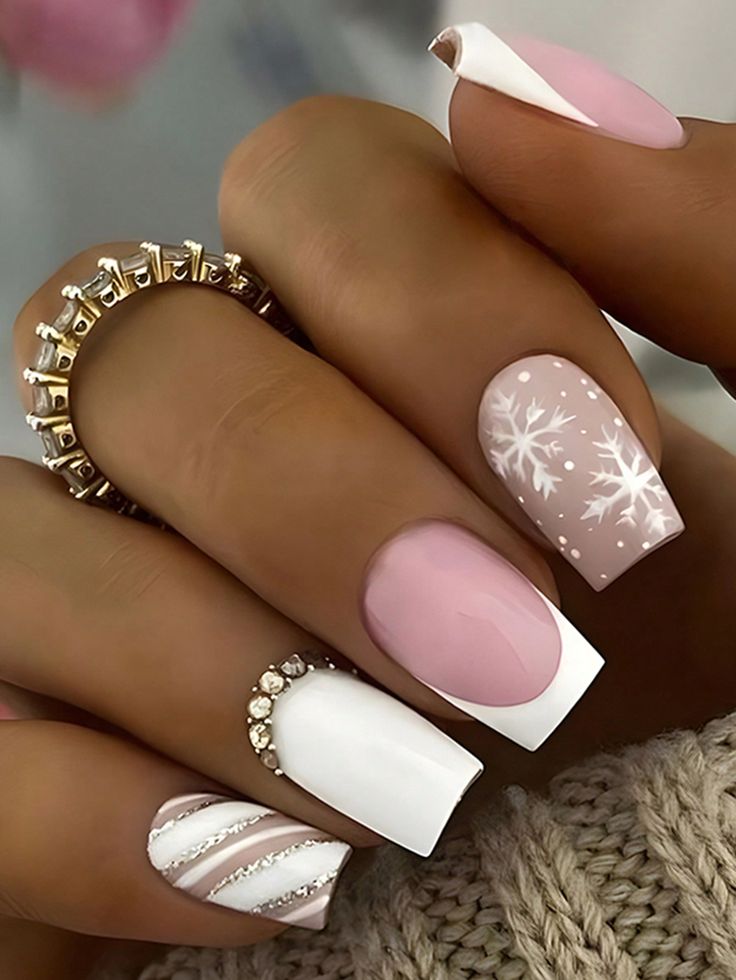 Elegant Chic Winter Nail Design: Soft Pink and Crisp White Festive Patterns with Embellishments.