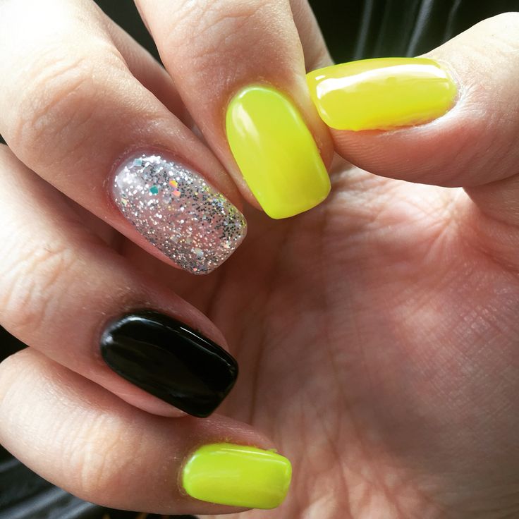 Eye-Catching Vibrant Nail Design: Neon Yellow, Bold Black, and Sparkly Silver Accents