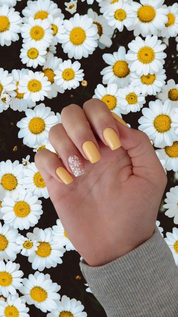 Cheerful Spring-Inspired Yellow Nail Design with Glossy Finish and Floral Accent.