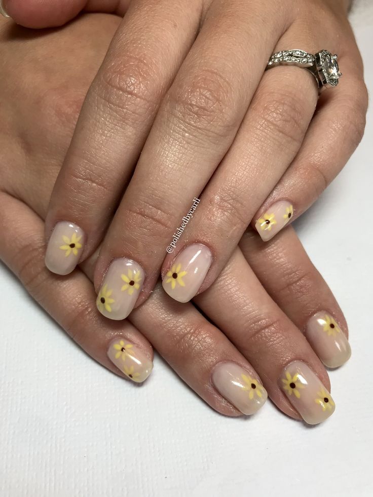 Elegant Floral Nail Art in Soft Nude and Cheerful Yellow Hues.