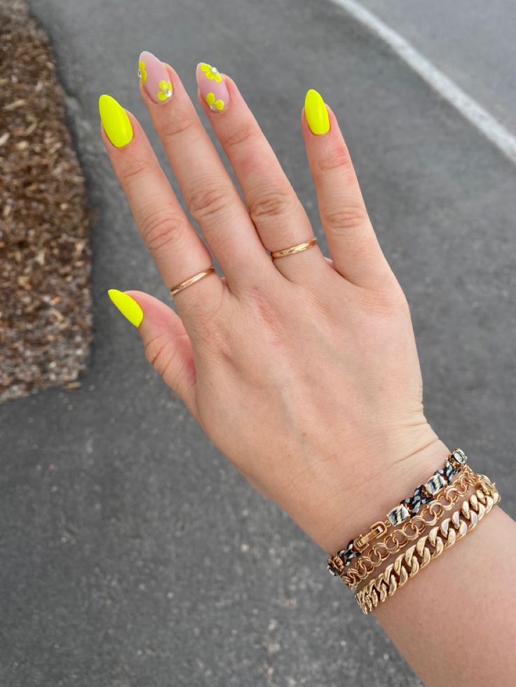 Bold Summer Nail Design: Bright Yellow and Pastel Pink with Floral Accents and Gold Accessories.