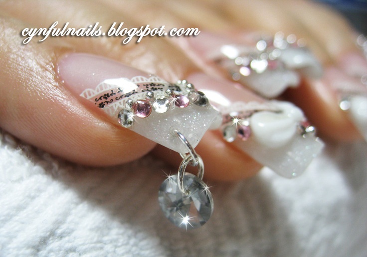 Elegant Nail Design with Sparkling Gemstones and Floral Embellishments