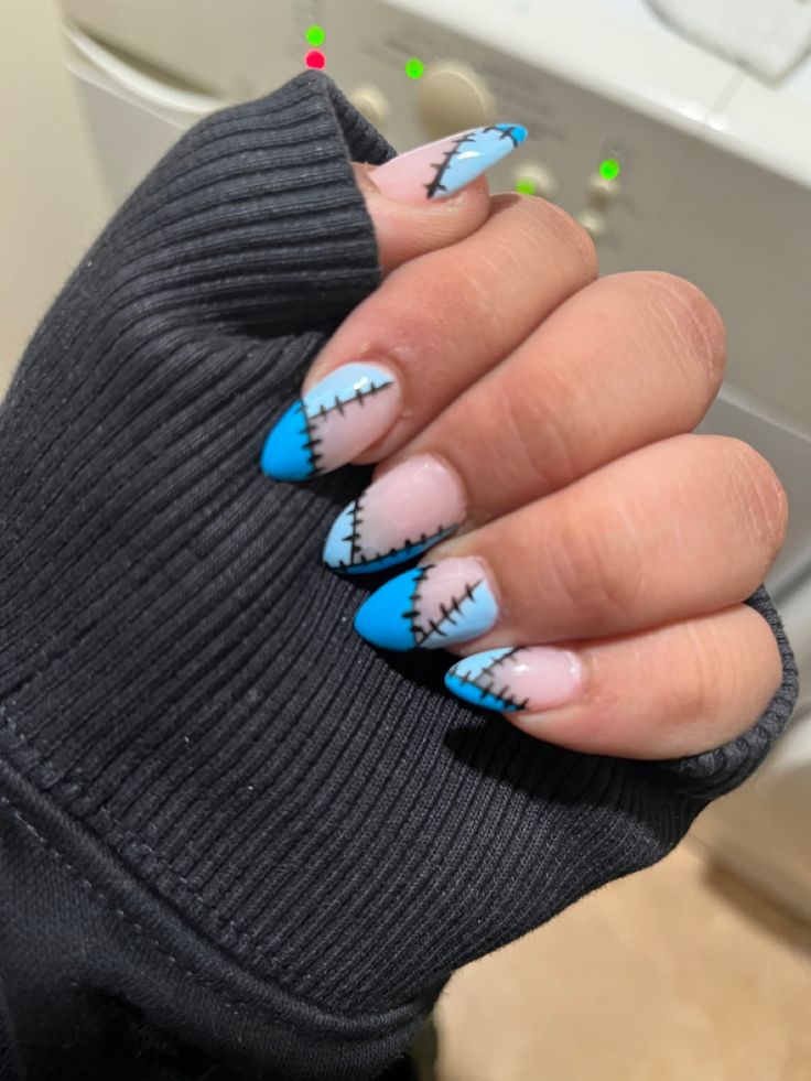 Edgy Dual-Toned Nail Art: Light Pink and Vibrant Blue with Decorative Black Stitching.