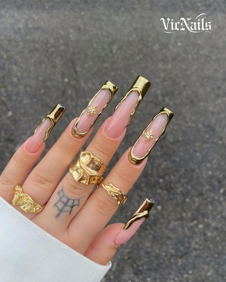 Luxurious Elongated Acrylic Nail Design with Gold Accents and Bold Accessories.