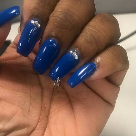 Striking Vibrant Blue Nails with Jewels and Trendy Metal Embellishments