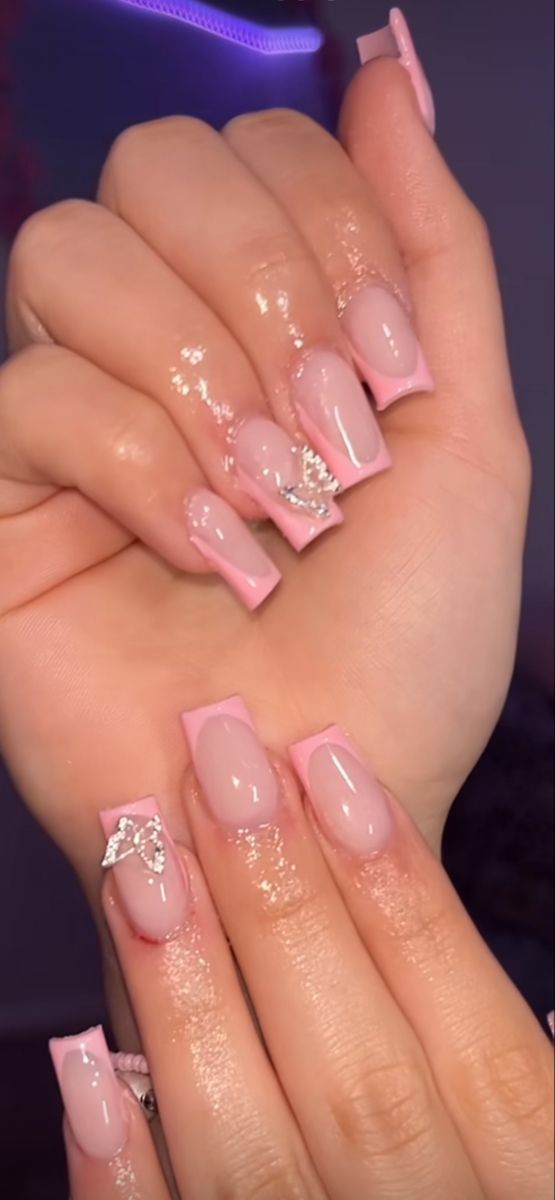 Elegant Pink Nail Design with Glossy Finish and Rhinestone Accents.