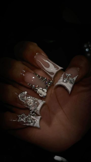 Glamorous Nude and White Nail Design with Rhinestones and Floral Accents.