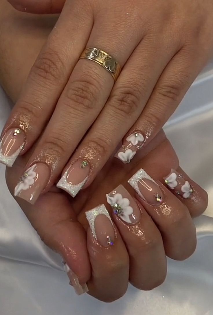 Chic Nude French Tips with Intricate Floral Patterns and Glitter Accents