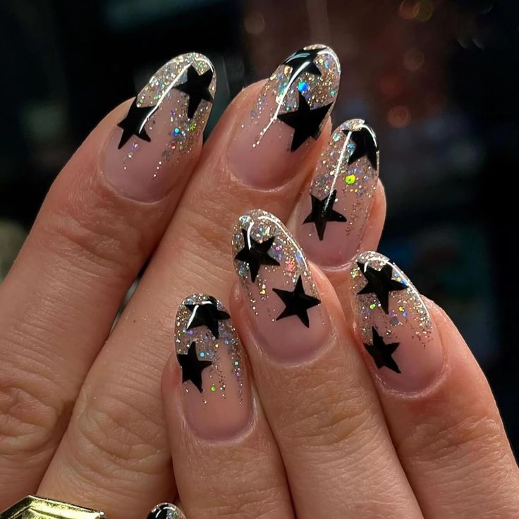 Celestial Glam: Sparkling Nude Nail Design with Bold Black Star Accents