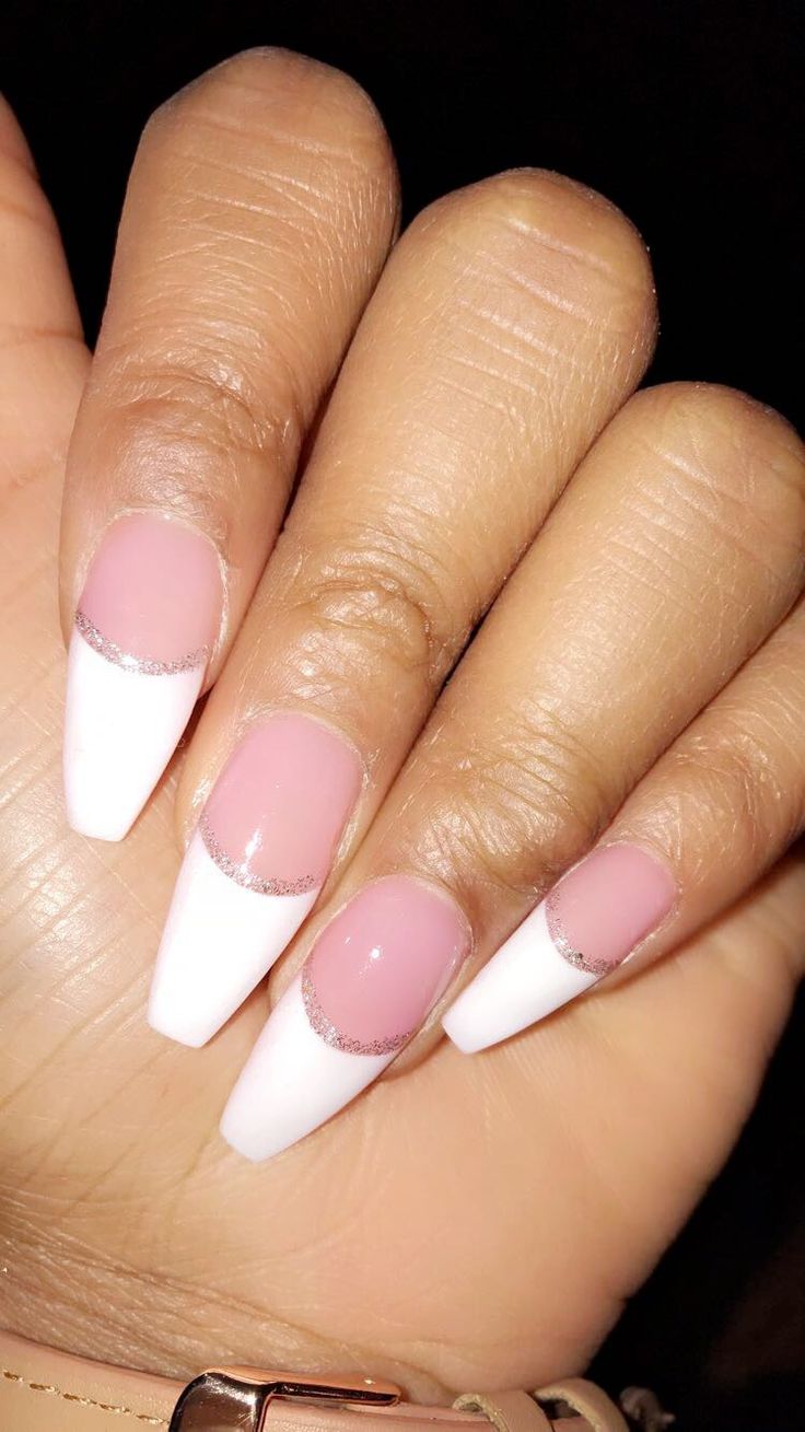 Chic French Manicure with Pastel Pink and Bold White Tips Enhanced by Silver Accents.