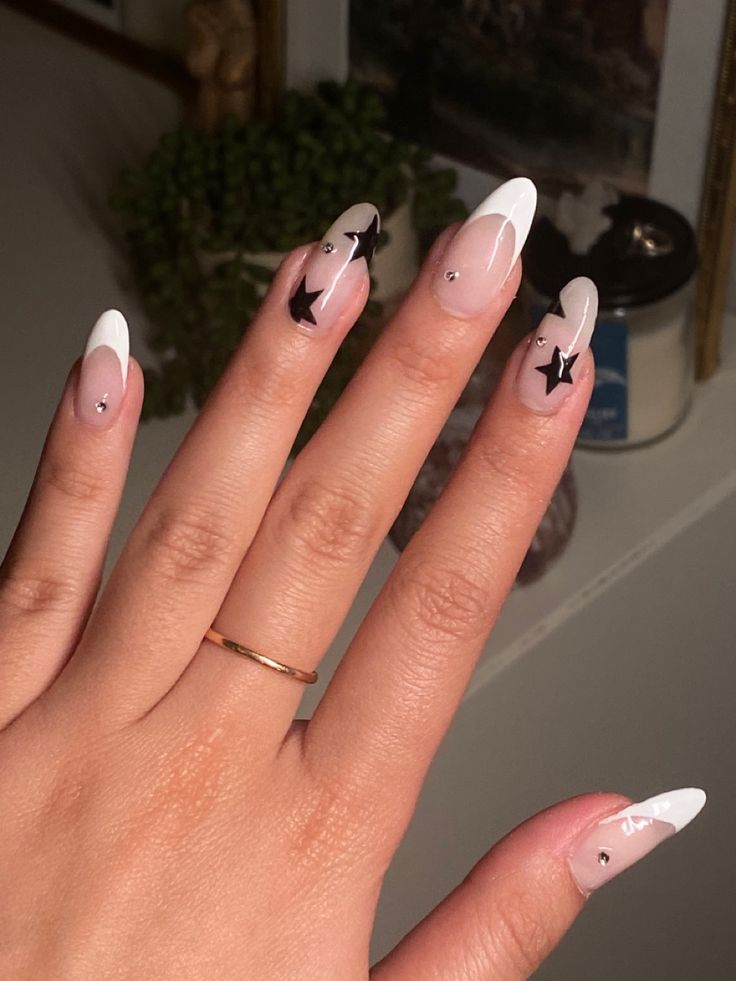 Chic Nail Design: Classic French Tips with Playful Black Star Accents