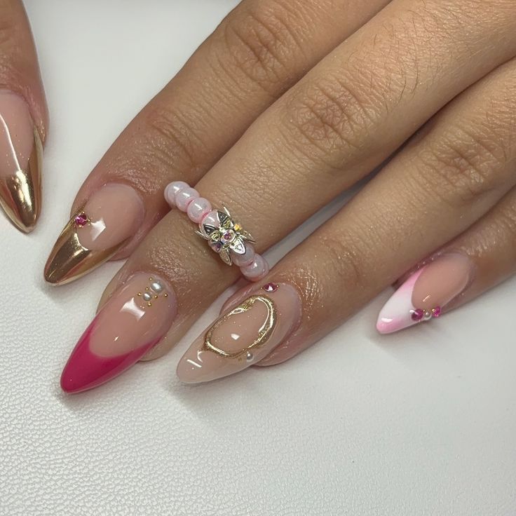 Sophisticated Nail Art: Nude and Metallic Tips with Gold and Pink Accents.