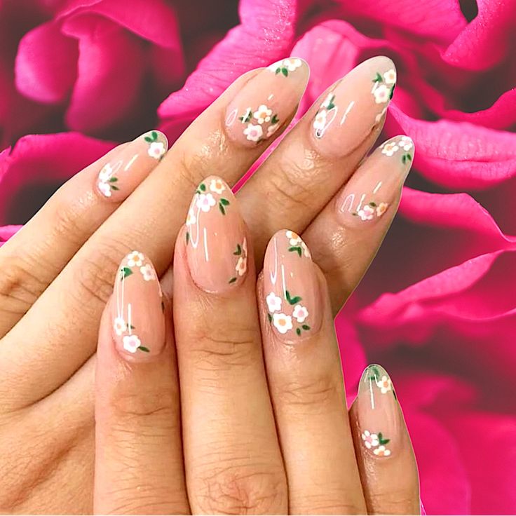 Elegant Floral Nail Design with Hand-Painted White Flowers and Green Leaves on a Nude Base.