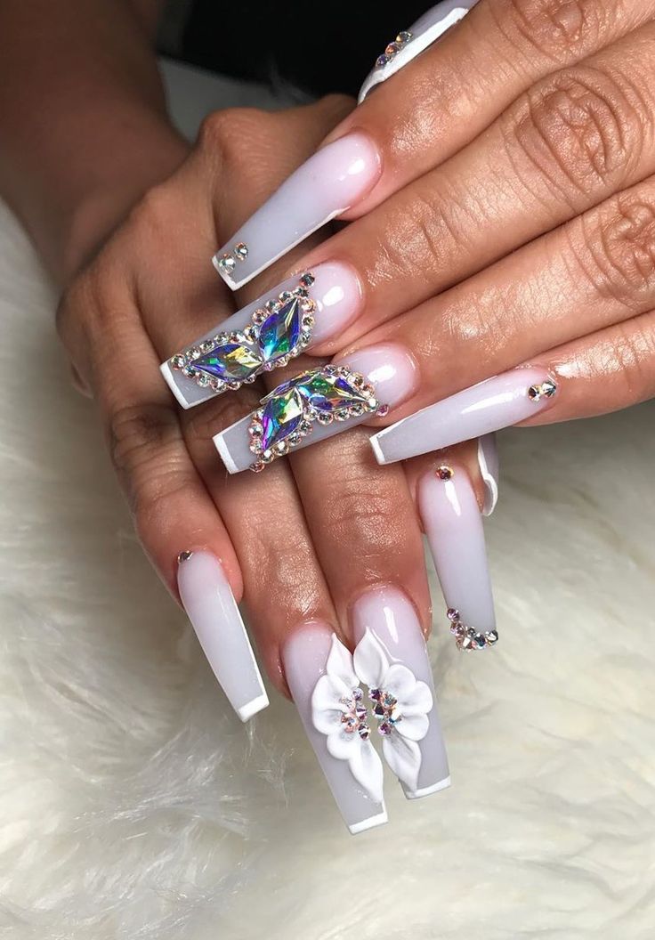 Luxurious Long Square Nail Design with Gradient Effect, Gemstones, and Floral Embellishments.