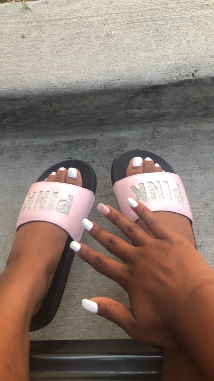 Chic Summer Vibes: White Nail Polish Paired with Playful Pink Slides.