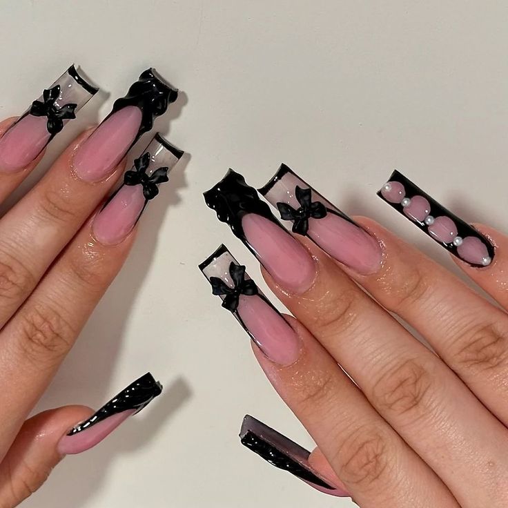 Chic Long Nails: Soft Pink Base with Bold Black Accents and Whimsical Details.