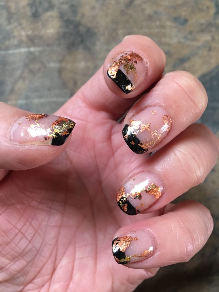 Elegant Black and Transparent Nail Design with Golden Flakes for a Sophisticated Look.