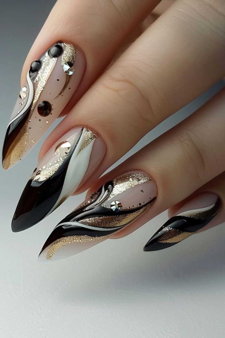 Sophisticated Nail Design: Striking Black, White, and Gold Elegance with Glamorous Embellishments.