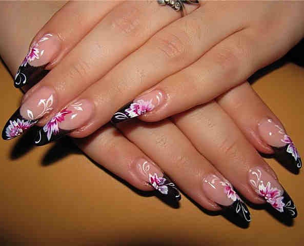 Elegant Floral Nail Design: Striking Black Tips with Soft Pink and White Accents.