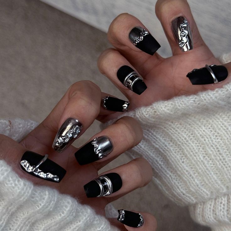 Bold Matte Black and Metallic Nail Design with Elegant Silver Detailing for a Modern Statement Manicure.