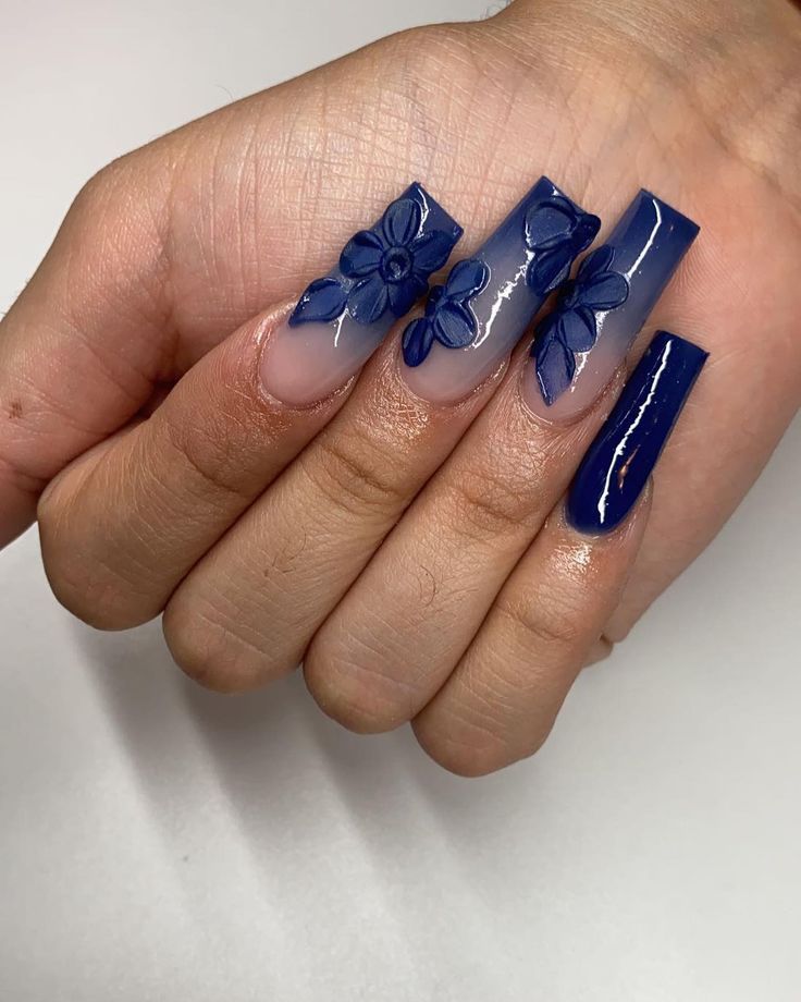 Chic Nail Design: Bold Deep Blue and Soft Nude with Intricate Floral Embellishments