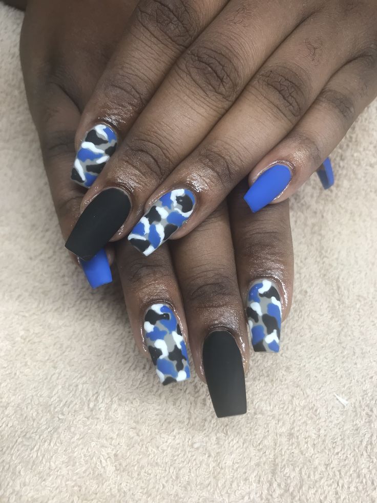 Bold Blue and Black Spotted Nail Design: A Striking Statement Manicure.