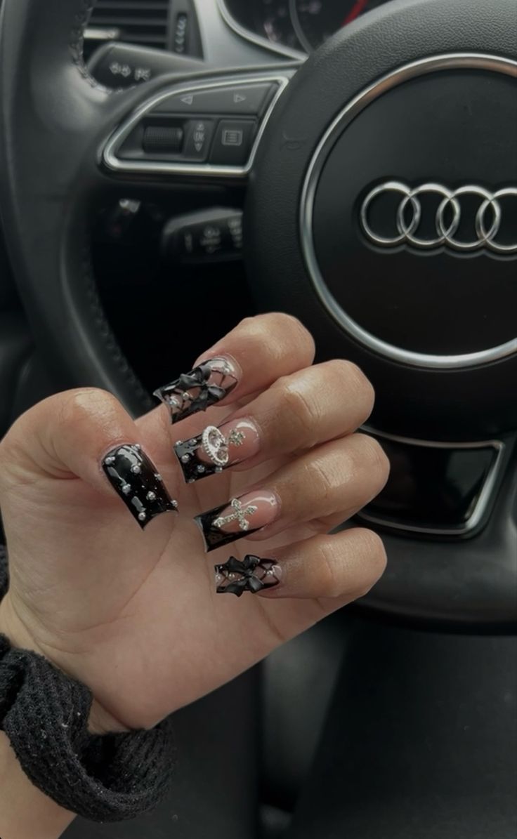 Bold and Glamorous Black and Transparent Nail Design with Intricate Details.