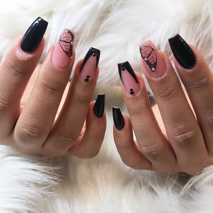 Sophisticated Nail Design: Glossy Black Tips, Soft Pink Base, and Delicate Butterfly Accents.