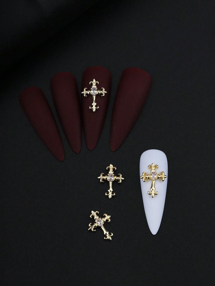 Chic Deep Burgundy and White Nail Design with Elegant Golden Cross Accents