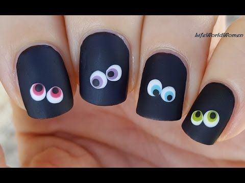 Whimsical Matte Black Nail Art with Colorful Oversized Eye Decals