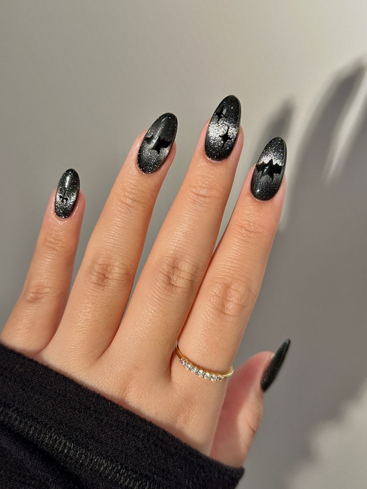 Chic Almond-Shaped Black Nails with Silver Glitter Waves for a Bold, Sophisticated Look.