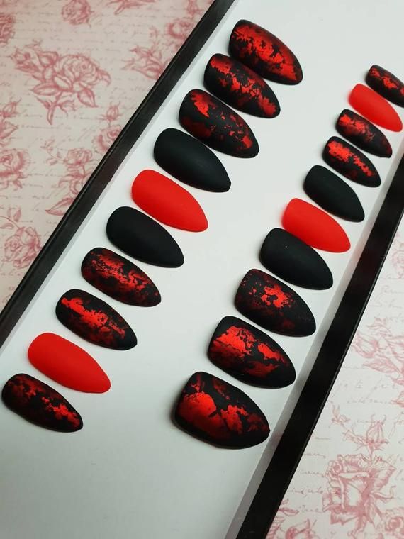 Bold Black and Red Matte Nail Designs with Intricate Patterns.