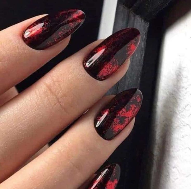 Fierce Almond-Shaped Nail Design: Glossy Black Base with Intricate Red Accents.