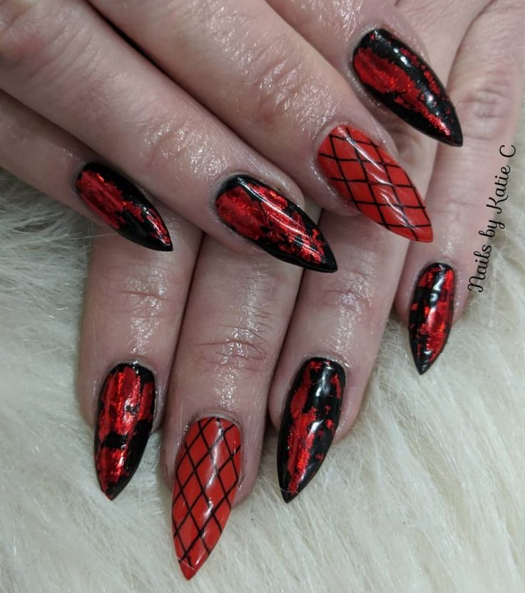 Dynamic Striking Nail Design: Glossy Black and Vibrant Red with Edgy Stiletto Shape