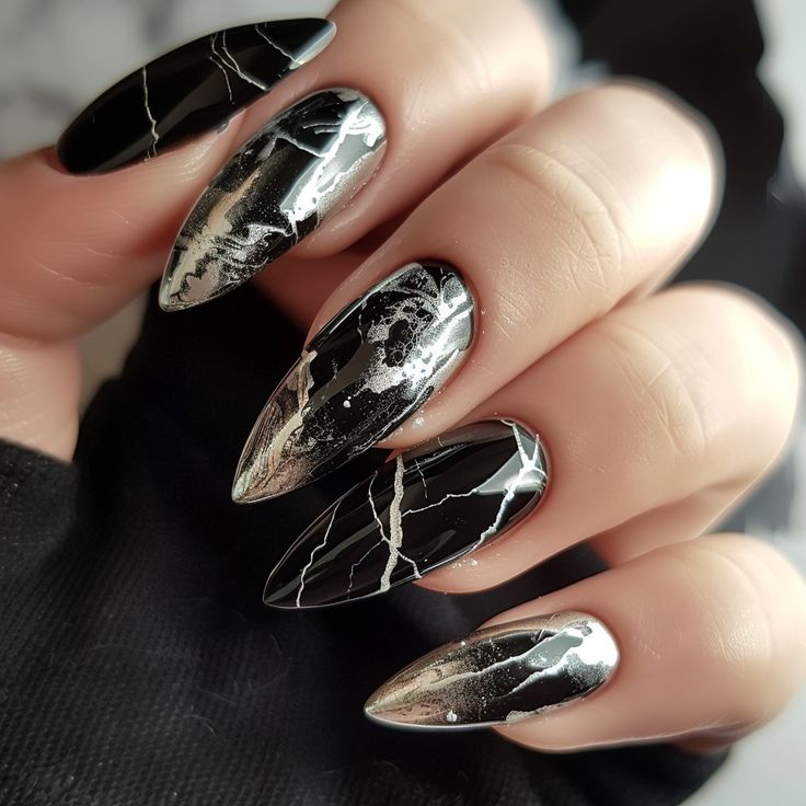 Elegant Black Stiletto Nails with Striking White Marbling Design