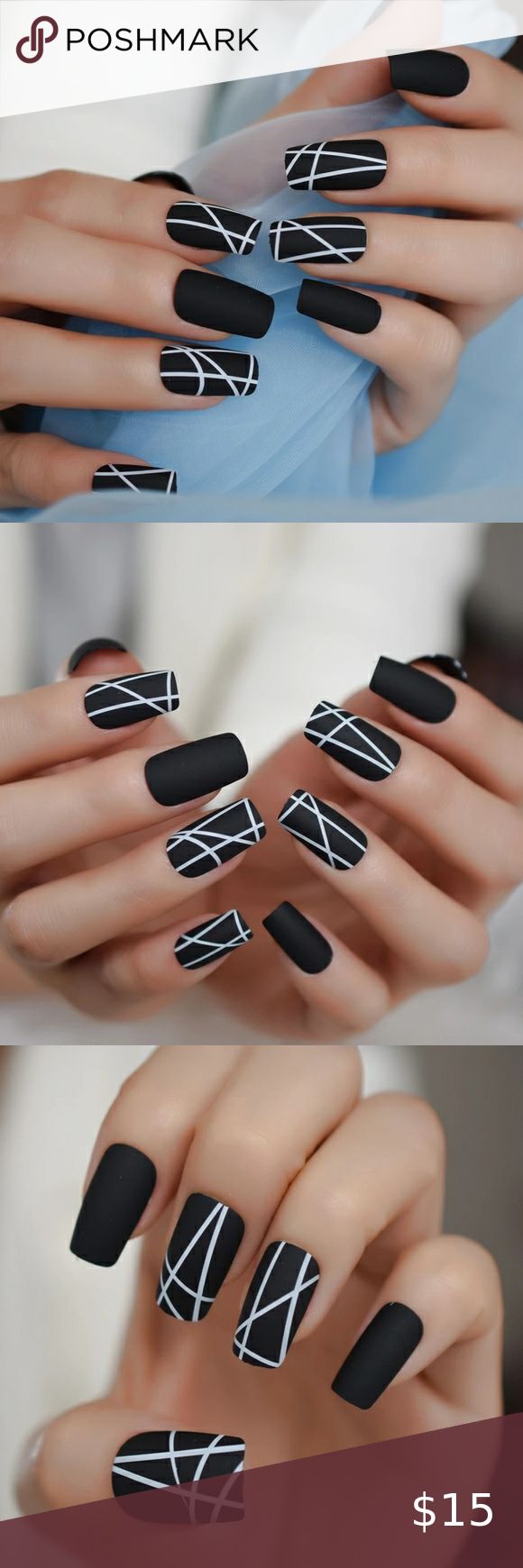 Chic Geometric Nail Design with Matte Black Base and Bold White Lines.