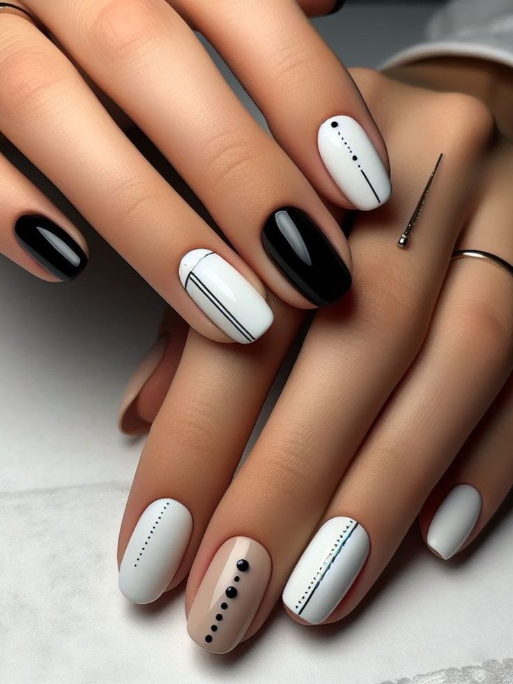 Sophisticated Monochrome Nail Design with Glossy Black and White Accents.