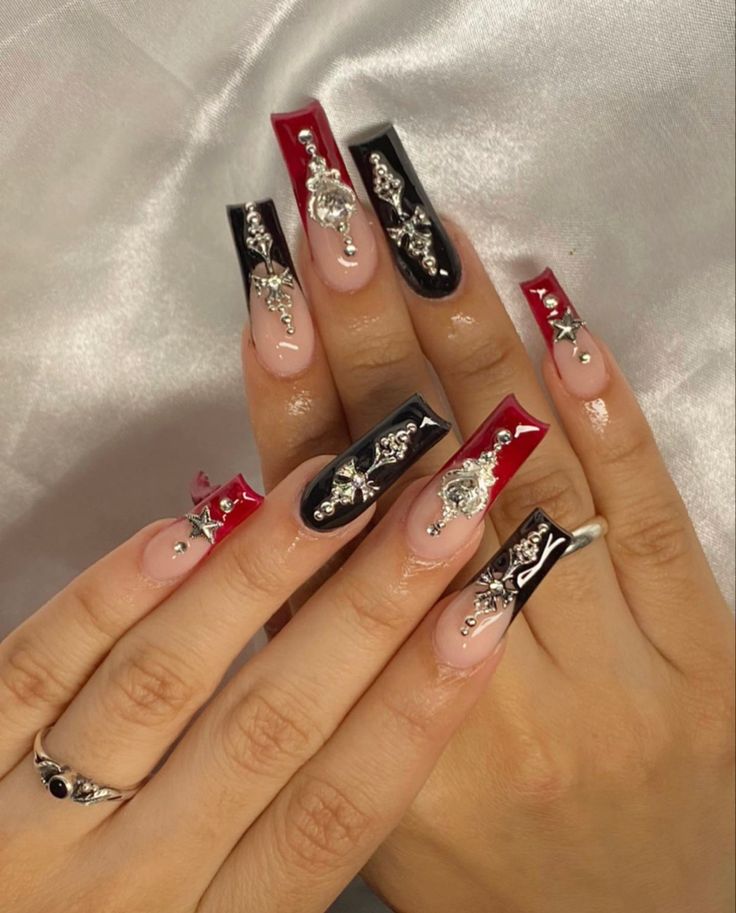 Bold Black and Red Nail Design with Elegant Embellishments for a Statement Manicure.