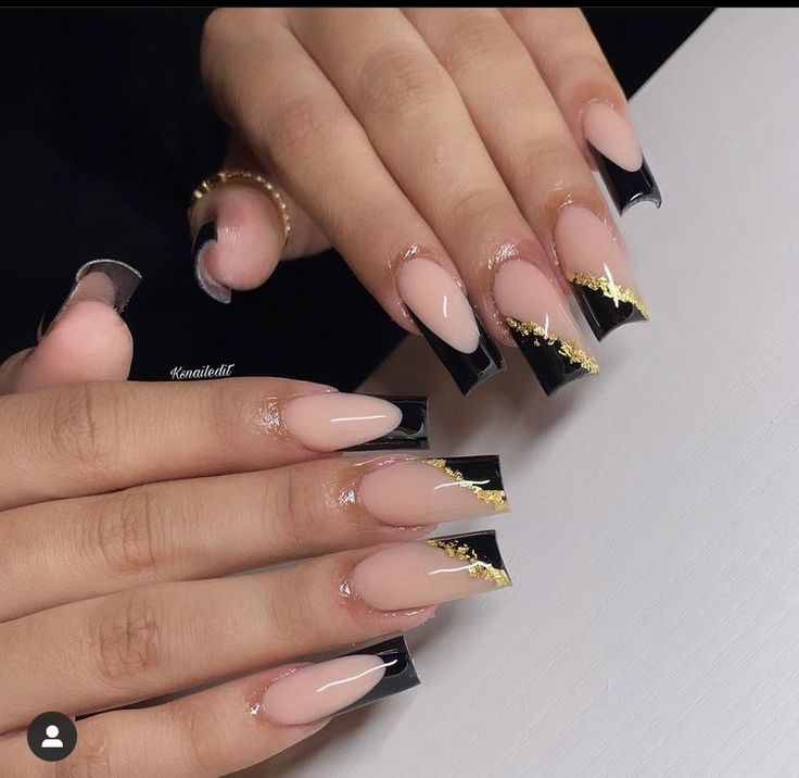 Chic Nude and Black Nail Design with Striking Gold Accents