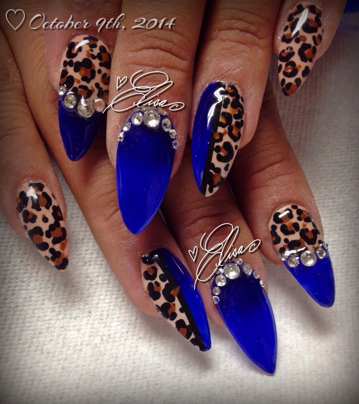 Vibrant Blue and Leopard Print Nail Design with Glam Metallic Accents.