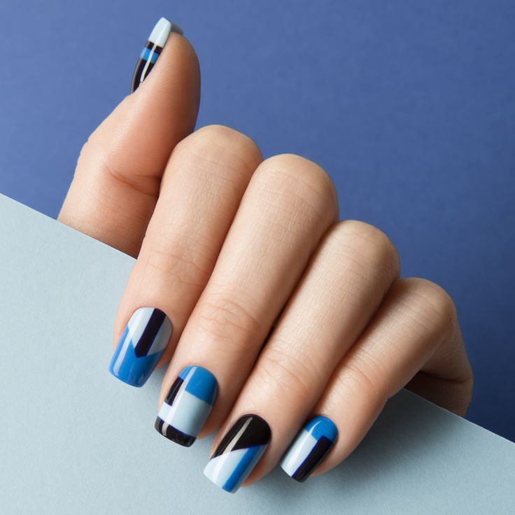 Bold Geometric Nail Design in Blue, Black, and White for a Chic Statement Look.