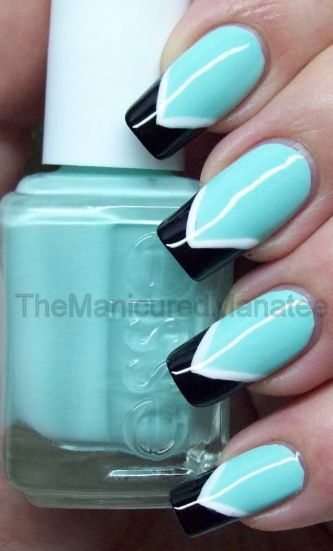 Chic Mint Green Nail Design with Bold Black Tips and Geometric White Accents.