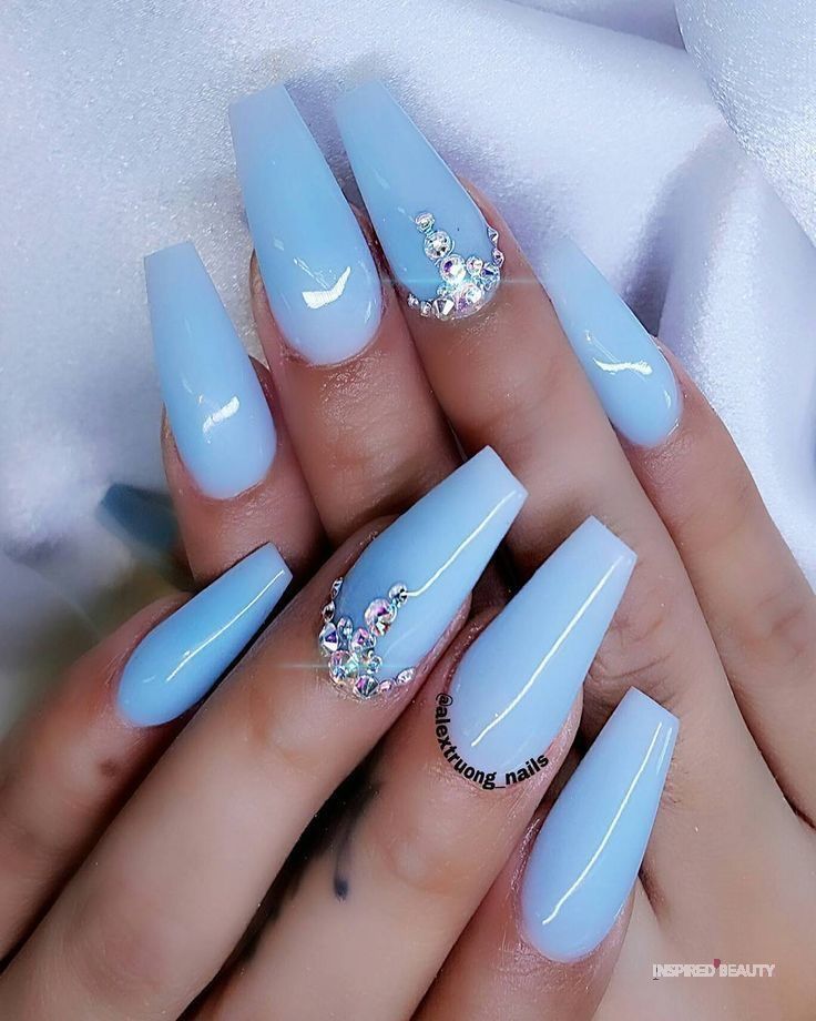 Serene Glossy Blue Nails with Pastel Hues and Shimmering Rhinestones for Any Occasion