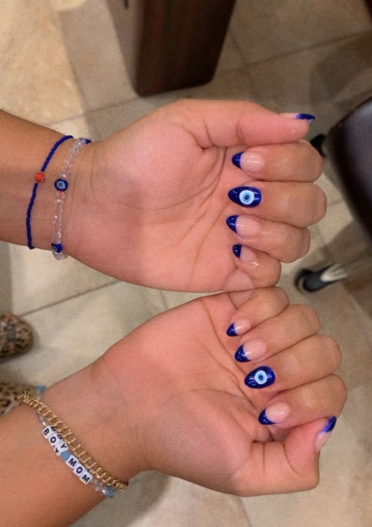 Vibrant Navy Blue Nail Design with Eye Motifs and Chic Summer Vibes