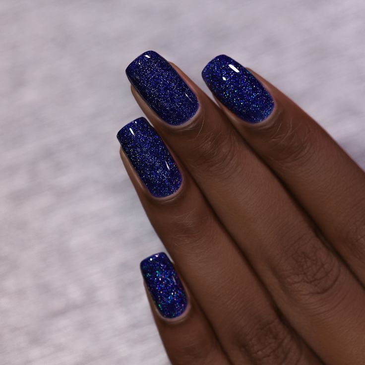 Elegant Sparkling Blue Nail Design: Deep Navy with Shimmering Glitter Finish.