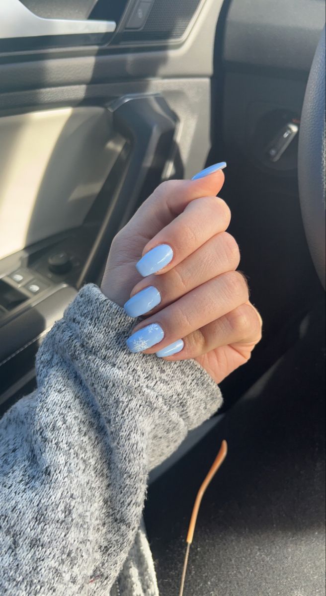 Elegant Light Blue Nail Design with Glossy Finish and Snowflake Accent for Versatile Winter Style.