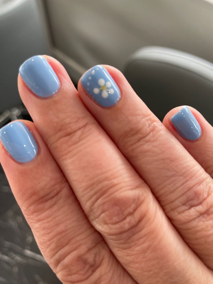 Charming Pastel Blue Nail Design with Floral Accents for Versatile Style